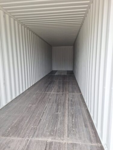 Interior of an empty 40ft shipping container with clean metal walls and a wooden floor, ready for storage or cargo transport